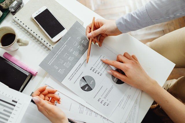 a person reading data documents at a desk